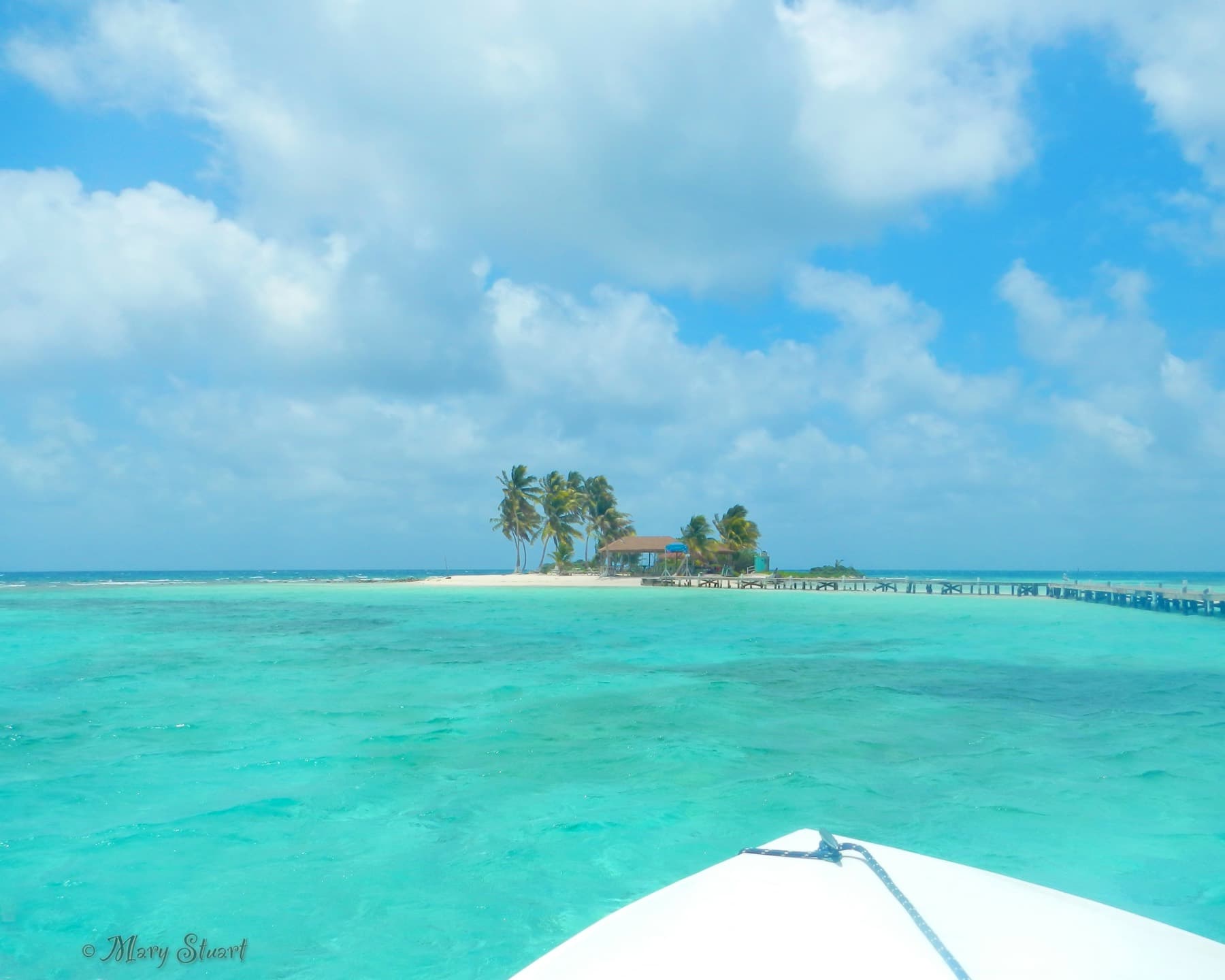 Goff’s Caye seen across electric blue Caribbean water