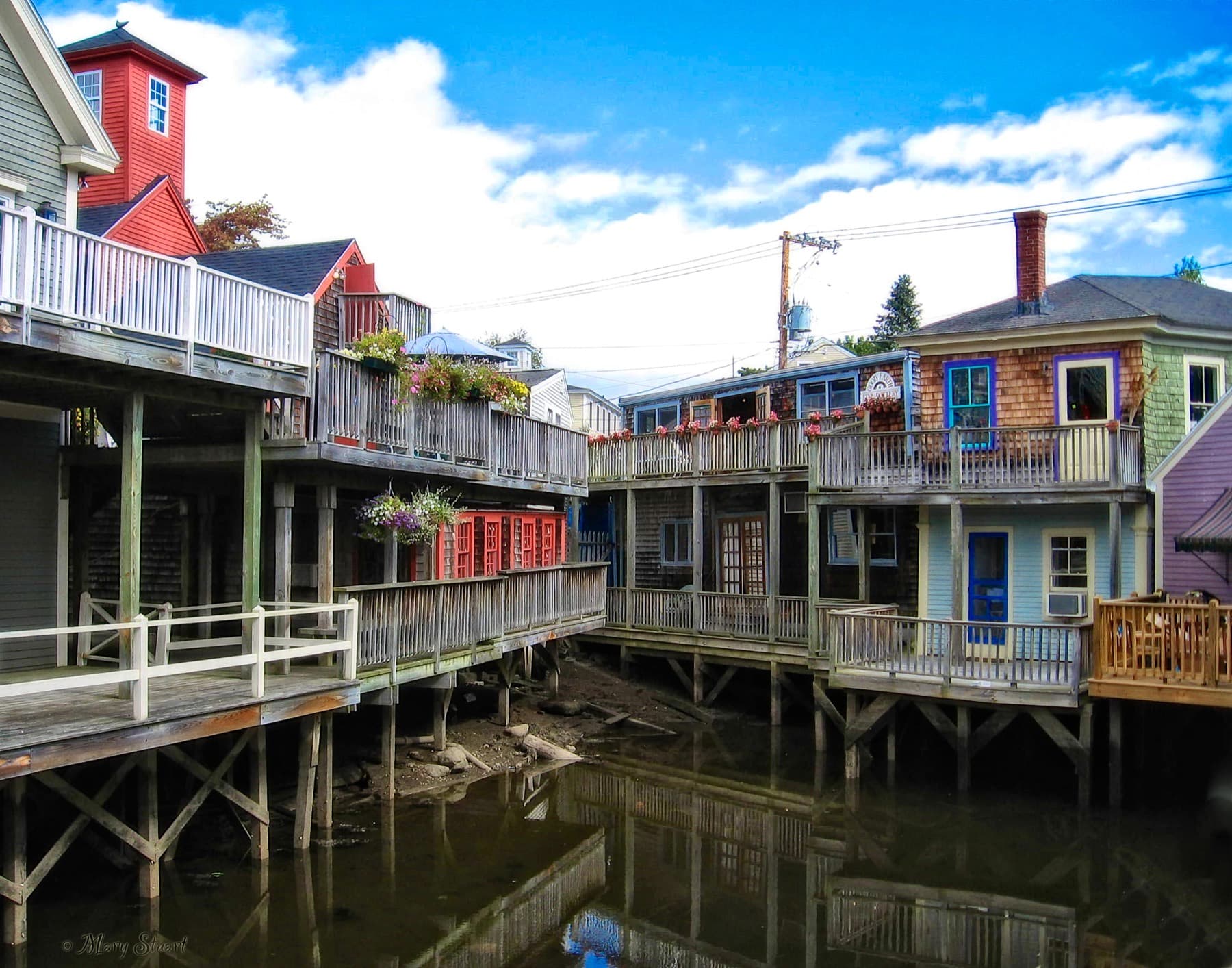 Colorful old buildings lining the Kennebunk River in Kennebunkport